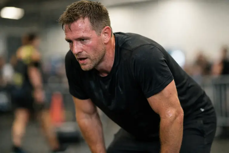 Athlete catching their breath after intense running effort during functional fitness training