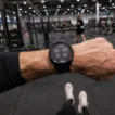 Best watch for HYROX — first-person POV of athlete checking GPS watch during indoor race