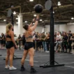HYROX doubles strategy at Wall Balls — one athlete throws while their partner recovers beside them at the same station