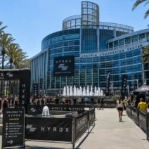Athletes gathered outside the Anaheim Convention Center for HYROX Anaheim, palm-lined plaza entrance