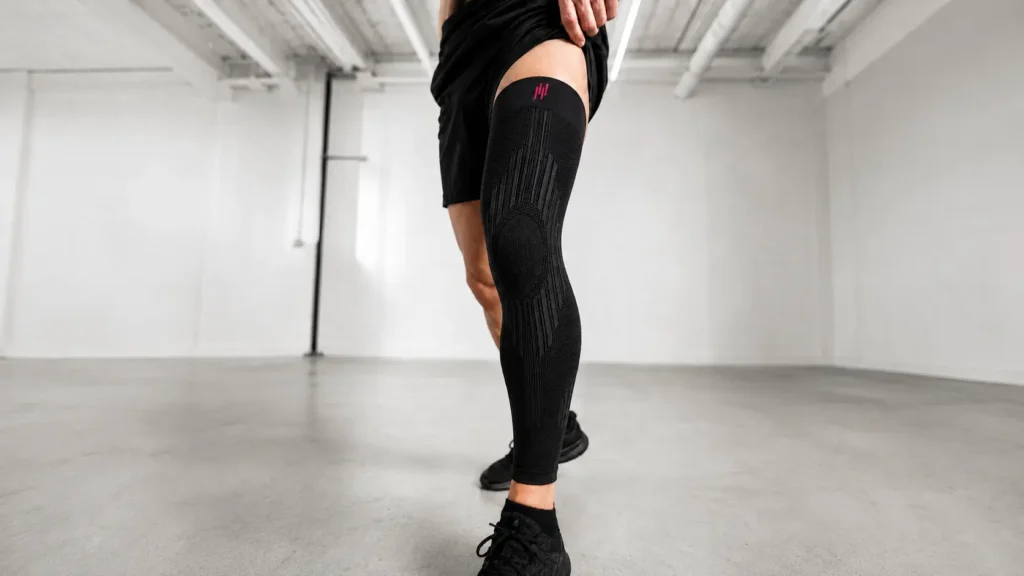 Athlete wearing a HYROX knee-to-thigh compression sleeve, one of the best HYROX equipment 2026 picks for knee stability