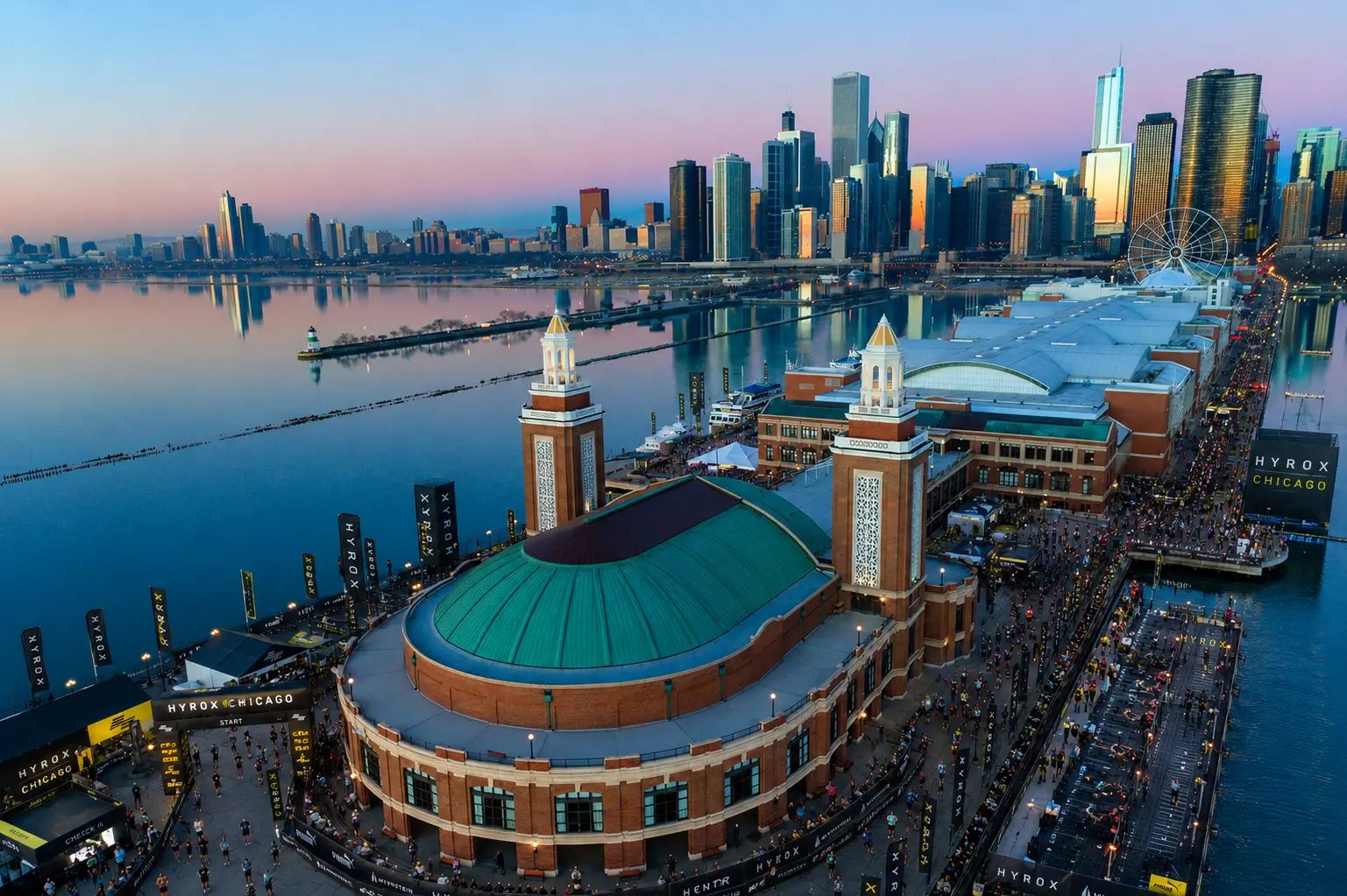 Aerial view of Navy Pier at sunset during a HYROX Chicago race, with the Chicago skyline in the background