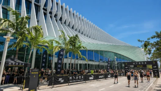 Miami Beach Convention Center exterior during a HYROX Miami race day, palm trees lining the entrance
