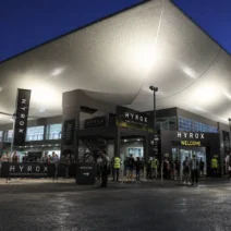 Entrance to the exhibition venue hosting HYROX Bari 2027 at dusk