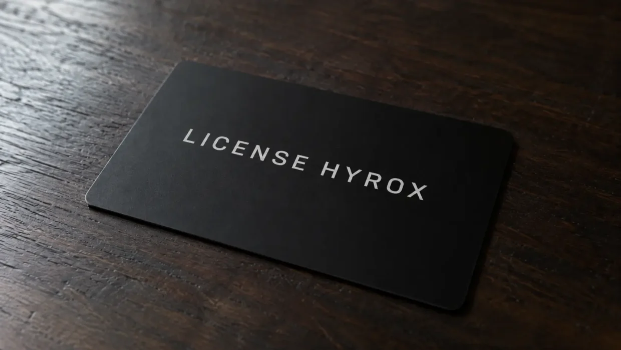 HYROX athlete license card resting on a wooden table