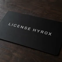 HYROX athlete license card resting on a wooden table