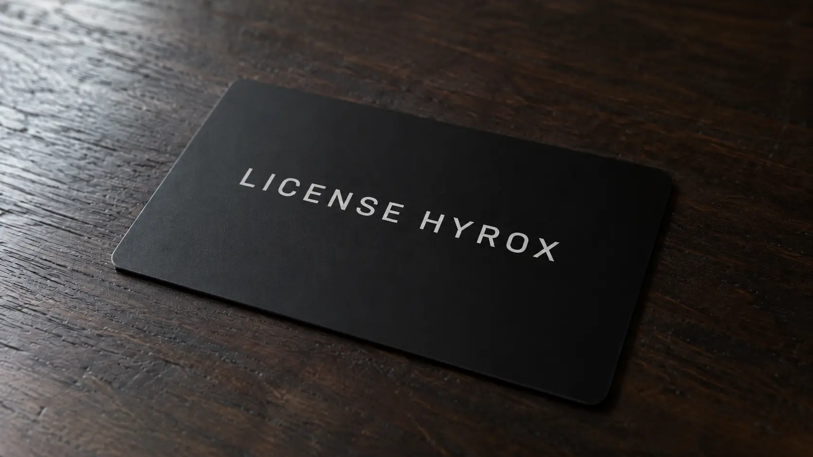 HYROX athlete license card resting on a wooden table