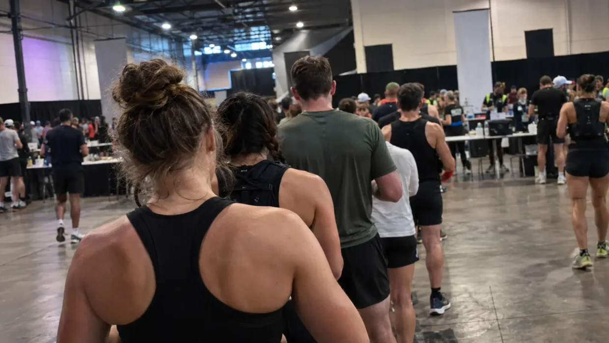Athletes queuing at a registration area, illustrating HYROX ticket transfer and check-in rules