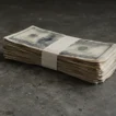 HYROX prize money 2026/27: stack of dollar bills on a concrete surface